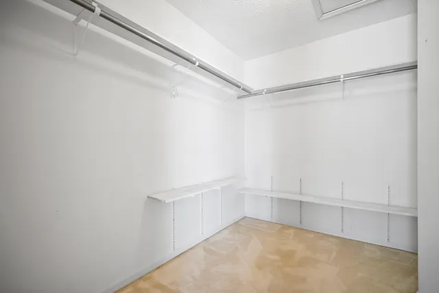 an empty room with closet and windows