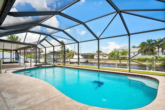 a view of a swimming pool with a yard