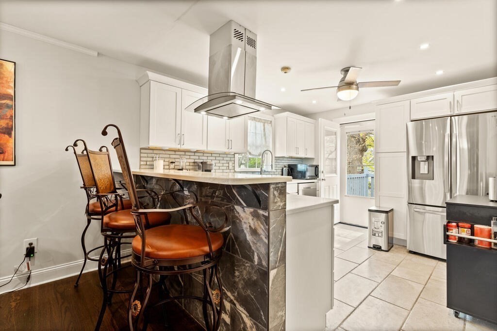 36 Violet Street Boston, MA 02126 - Photo 13 of 35 a dining room filled chandelier and wooden floor