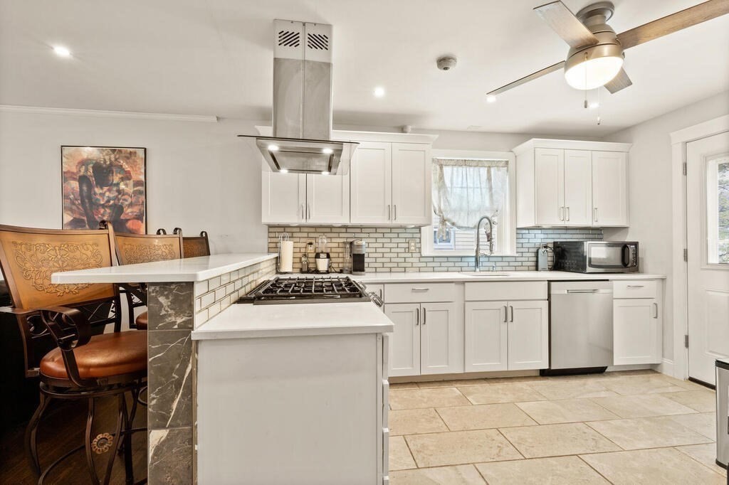 36 Violet Street Boston, MA 02126 - Photo 14 of 35 a kitchen with a stove a sink and a refrigerator