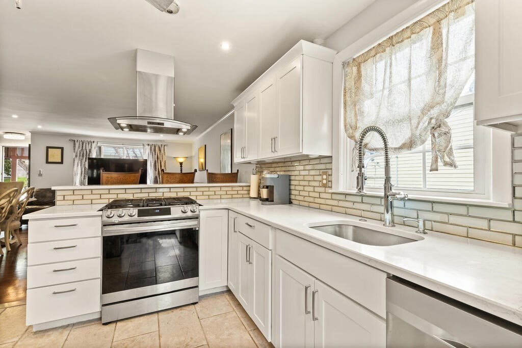 36 Violet Street Boston, MA 02126 - Photo 15 of 35 a kitchen with stainless steel appliances granite countertop a sink a stove and cabinets