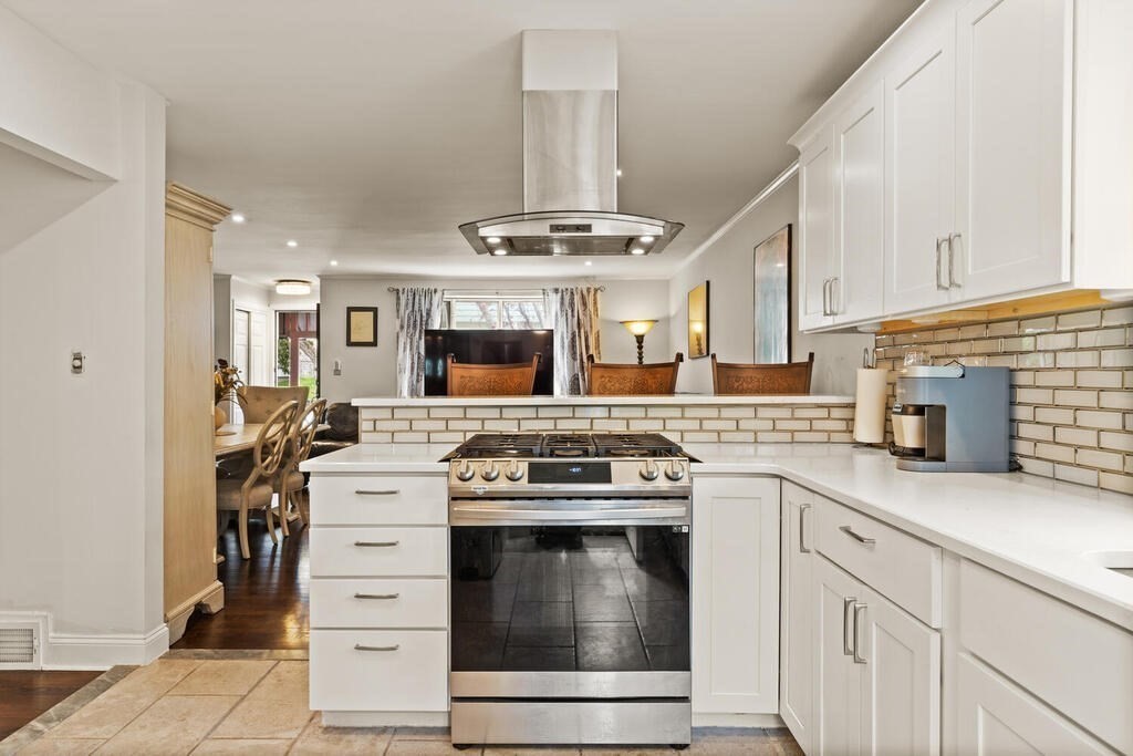 36 Violet Street Boston, MA 02126 - Photo 16 of 35 a kitchen with stainless steel appliances granite countertop a stove and a white cabinets