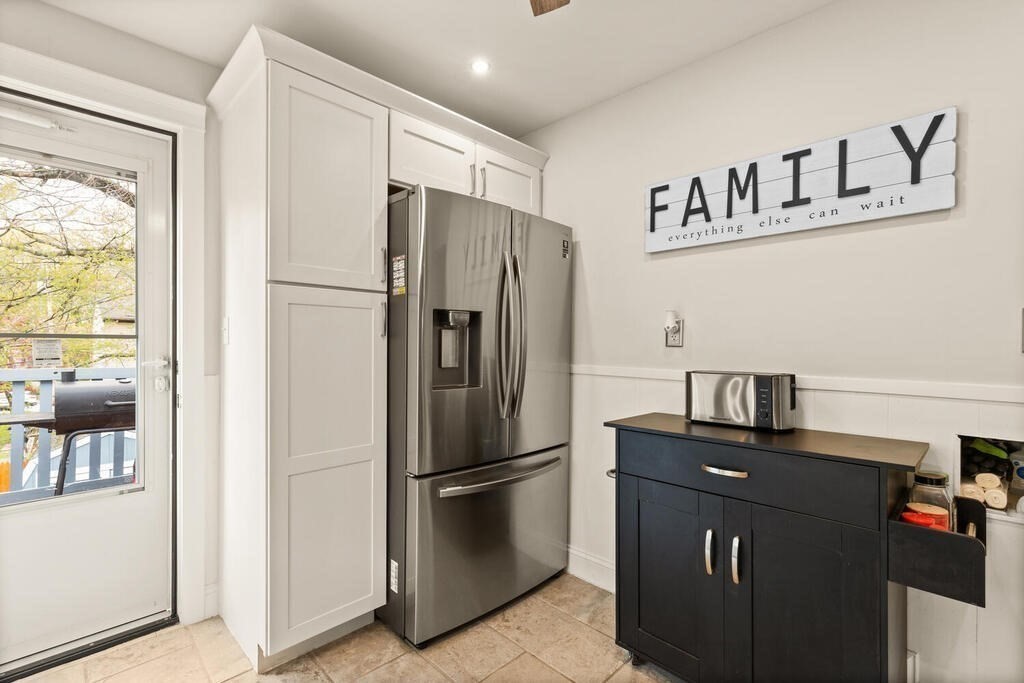 36 Violet Street Boston, MA 02126 - Photo 17 of 35 a kitchen with metallic refrigerator and cabinets