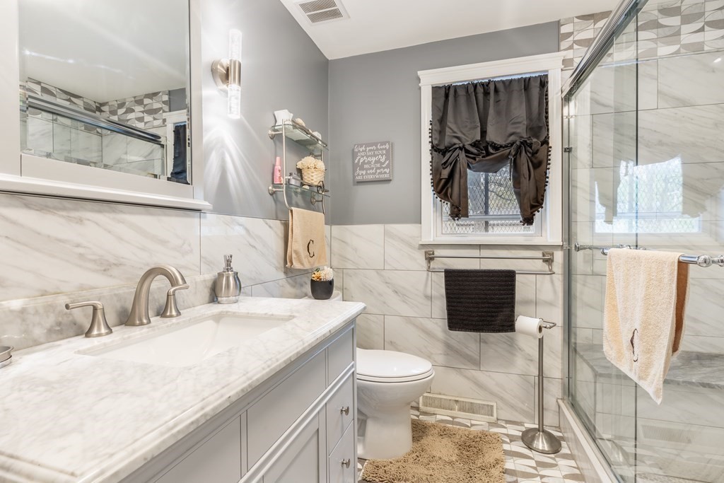 36 Violet Street Boston, MA 02126 - Photo 19 of 35 a bathroom with a sink toilet and shower