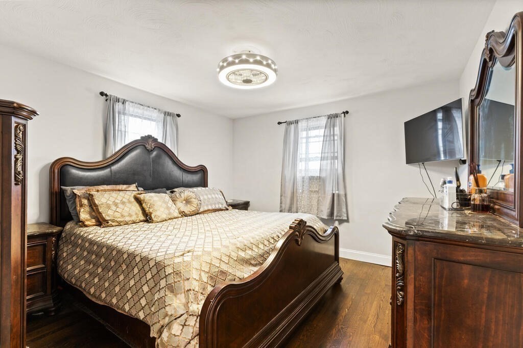 36 Violet Street Boston, MA 02126 - Photo 20 of 35 a bedroom with a bed and a flat screen tv