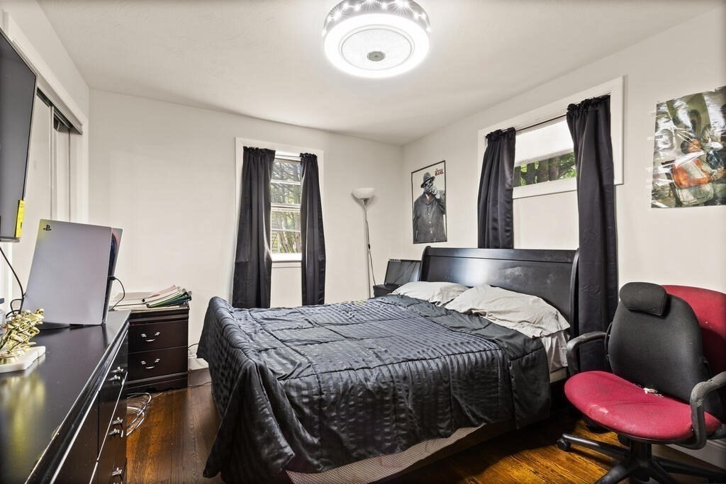 36 Violet Street Boston, MA 02126 - Photo 21 of 35 a bedroom with a bed and wooden floor