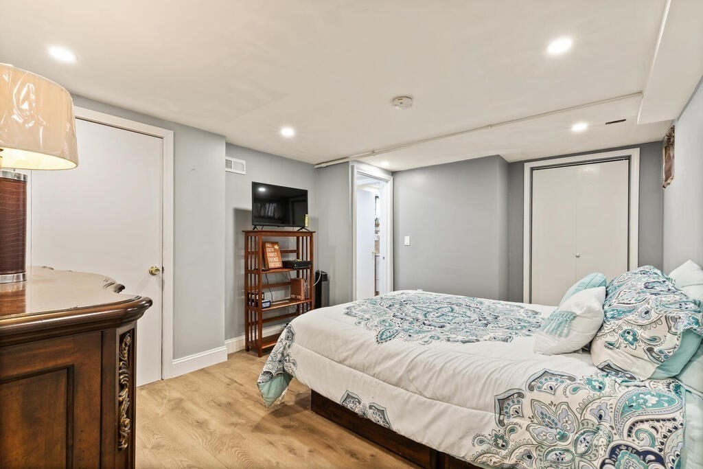 36 Violet Street Boston, MA 02126 - Photo 26 of 35 a bedroom with a bed and a television