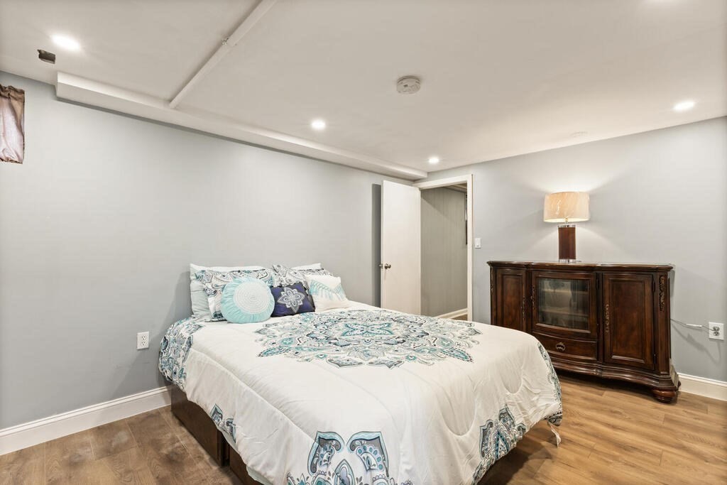 36 Violet Street Boston, MA 02126 - Photo 27 of 35 a bedroom with a bed and wooden floor