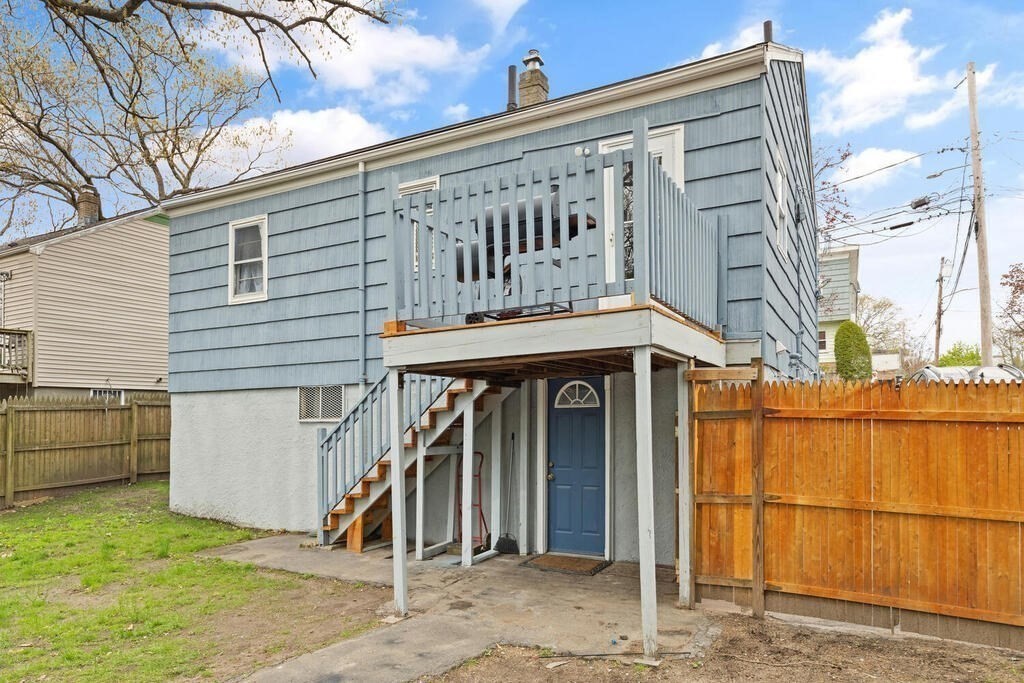 36 Violet Street Boston, MA 02126 - Photo 31 of 35 a view of a house with a wooden fence