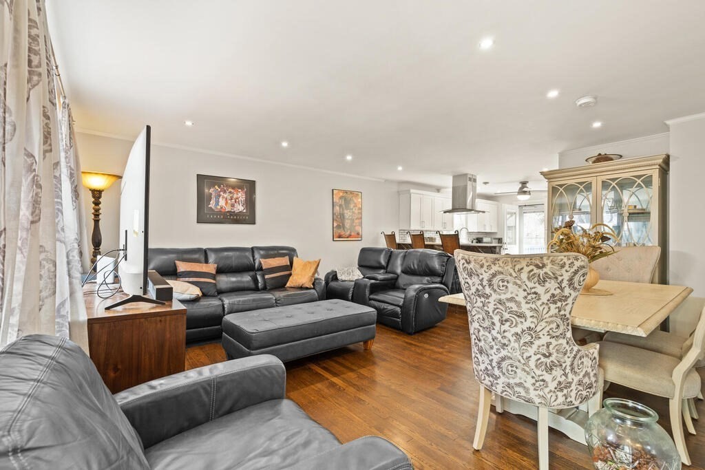 36 Violet Street Boston, MA 02126 - Photo 9 of 35 a living room with furniture kitchen view and a chandelier