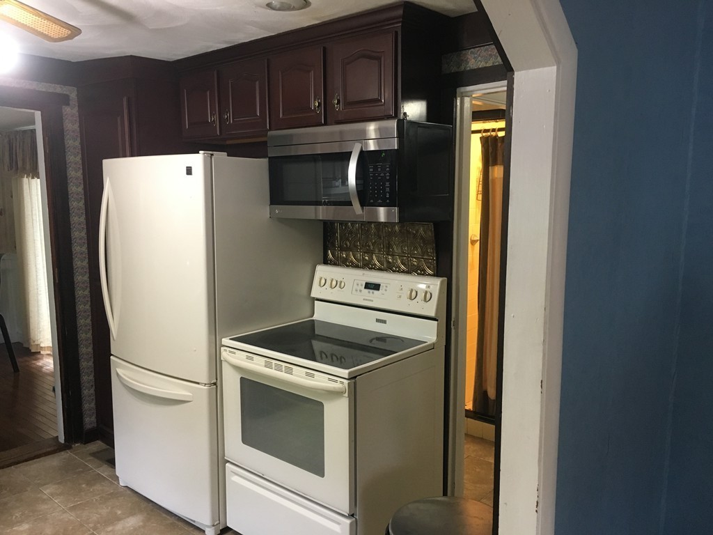 20 Arnold Road Douglas, MA 01516 - Photo 5 of 21 a kitchen with a refrigerator sink and cabinets