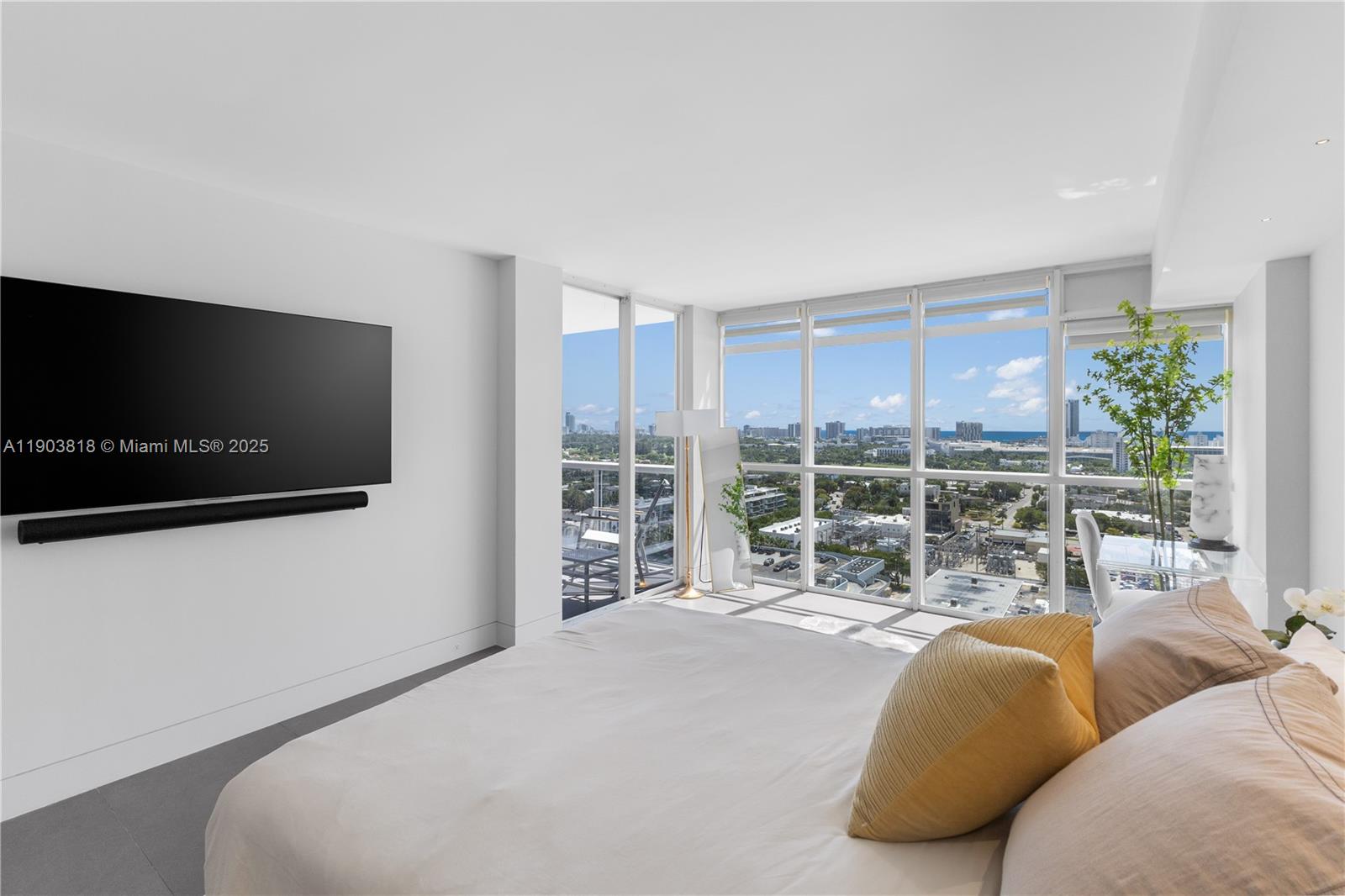 1800 Sunset Harbour Drive, Unit 2105 Miami Beach, FL 33139 - Photo 17 of 52 a living room with furniture a flat screen tv and floor to ceiling window