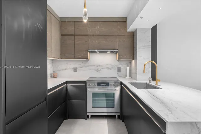 a kitchen with a sink and a stove top oven