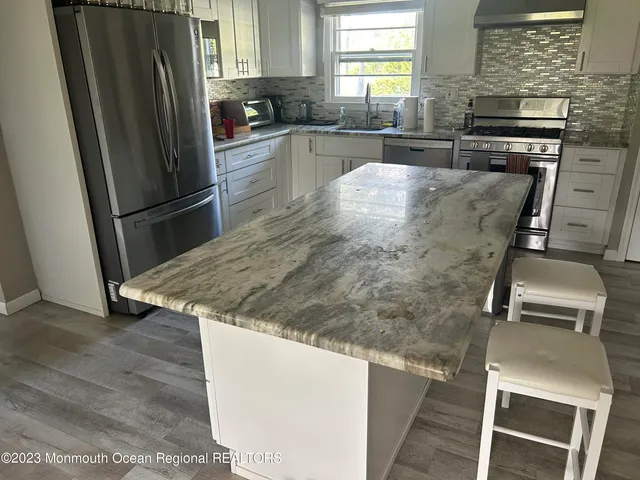 a kitchen with a refrigerator and a sink