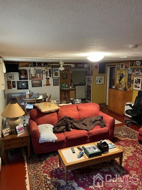 83 Brandywine Road Fords, NJ 08863 - Photo 22 of 31 a living room with furniture a rug and gym equipment