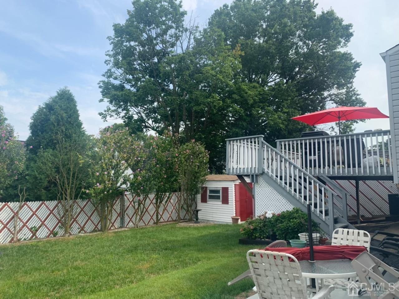 83 Brandywine Road Fords, NJ 08863 - Photo 5 of 31 a view of a table and chairs under an umbrella
