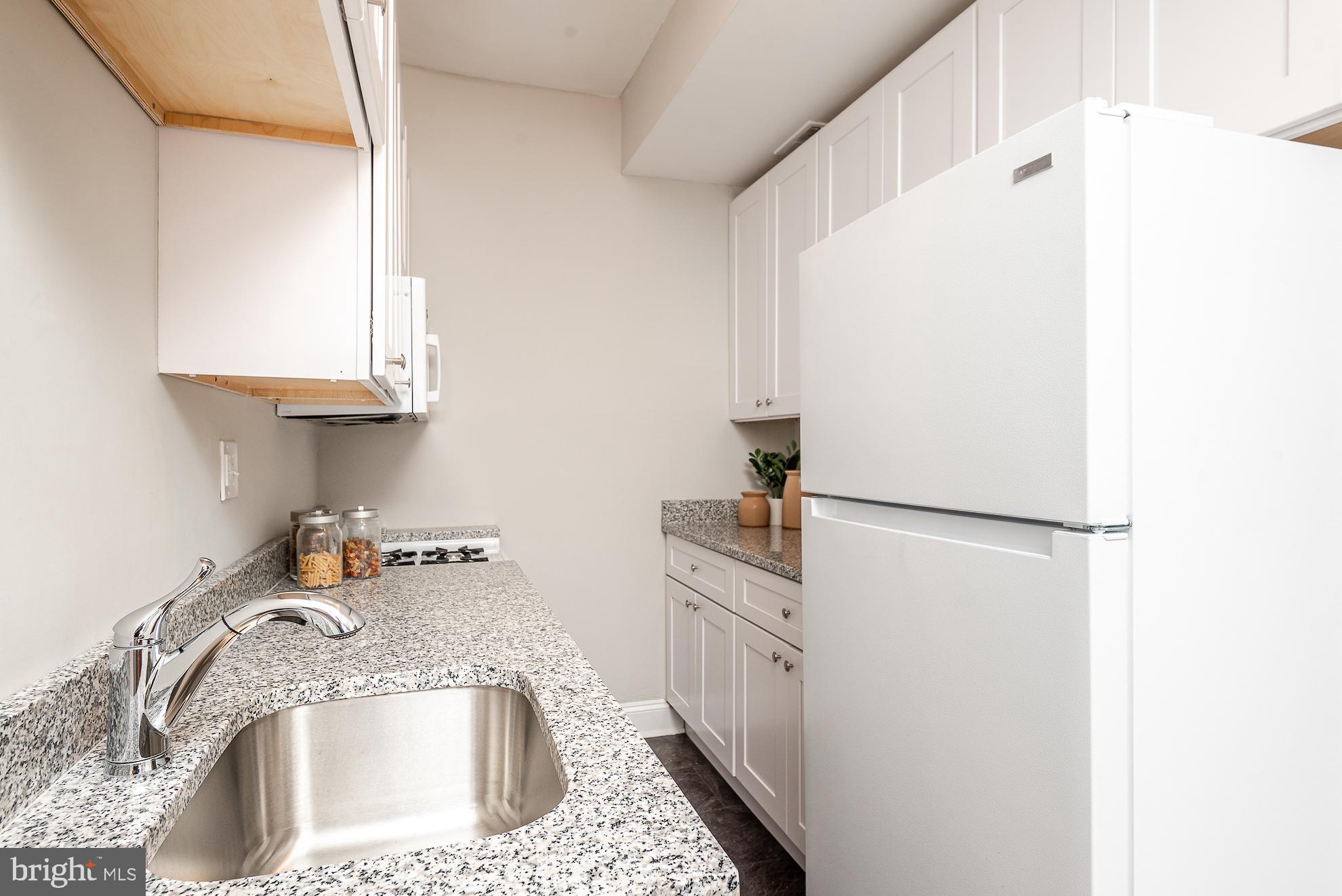 115 D Street Southeast, Unit 202 Washington, DC 20003 - Photo 13 of 17 Galley kitchen with gas stove