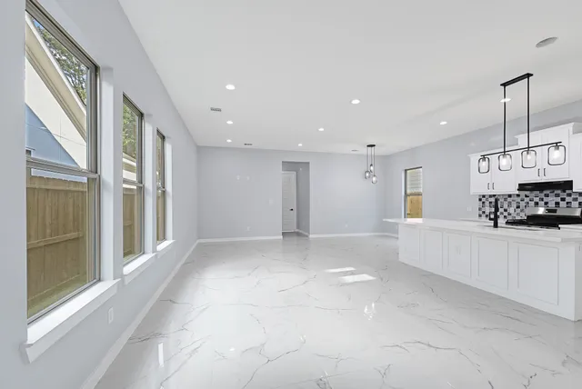a view of a kitchen with a sink and cabinets