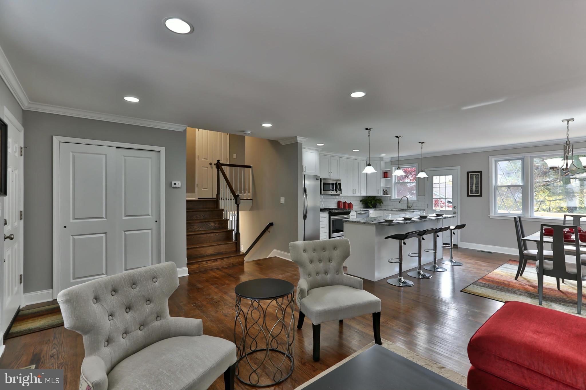 203 Hollen Road Baltimore, MD 21212 - Photo 4 of 30 a living room with furniture a wooden floor and a chandelier