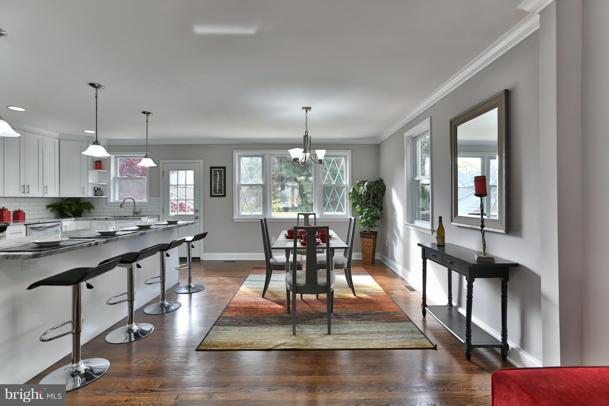 203 Hollen Road Baltimore, MD 21212 - Photo 6 of 30 a view of a dining room and livingroom with furniture wooden floor a chandelier