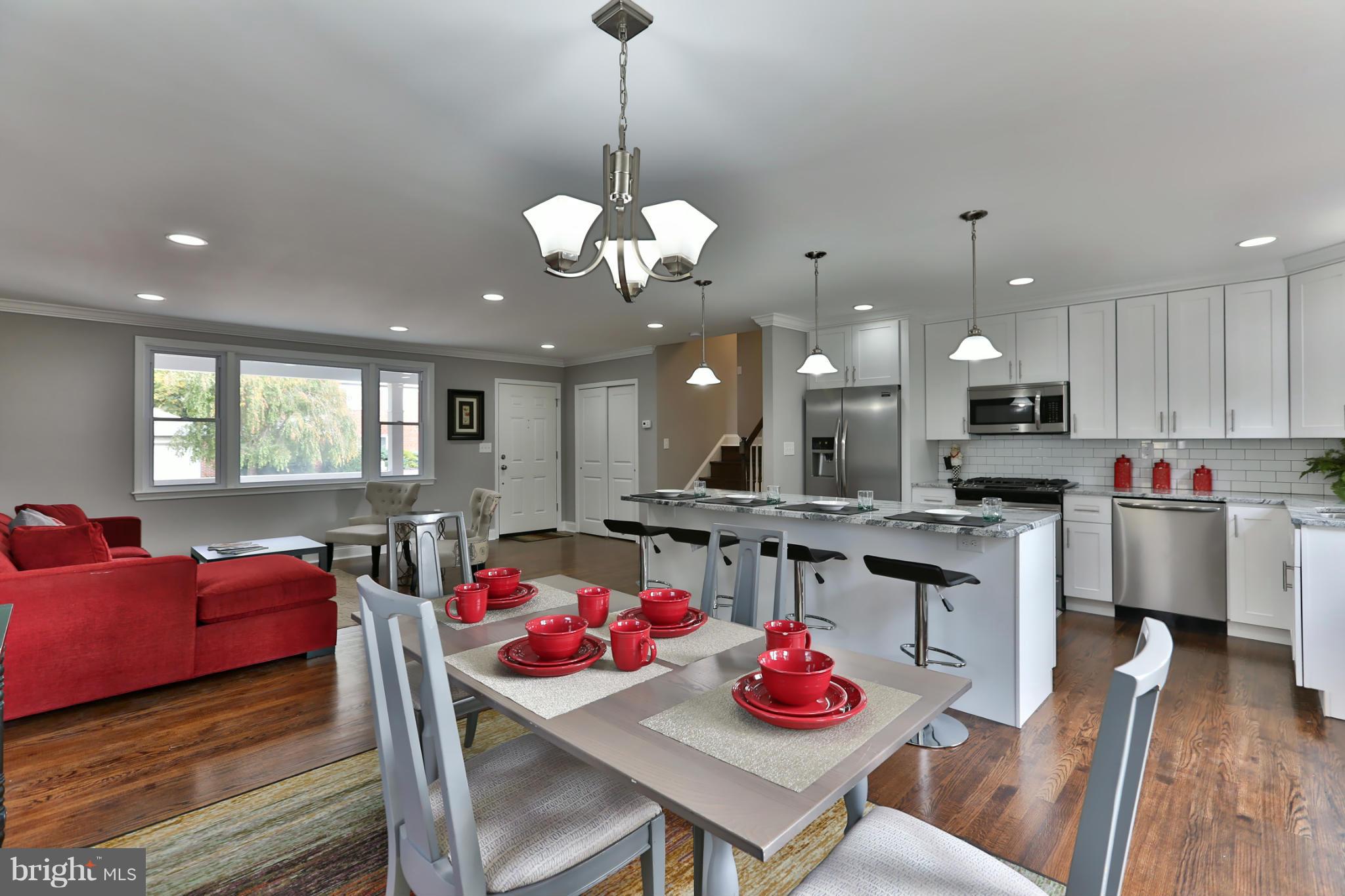 203 Hollen Road Baltimore, MD 21212 - Photo 7 of 30 a view of a dining room and livingroom with furniture wooden floor and a chandelier
