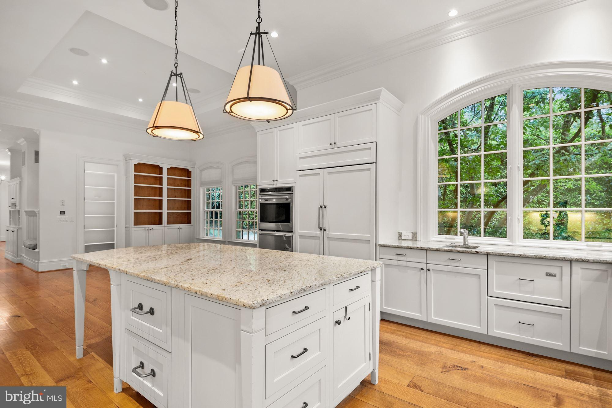 1107 Harvey Road McLean, VA 22101 - Photo 14 of 47 a kitchen with a stove a chandelier and a view of living room