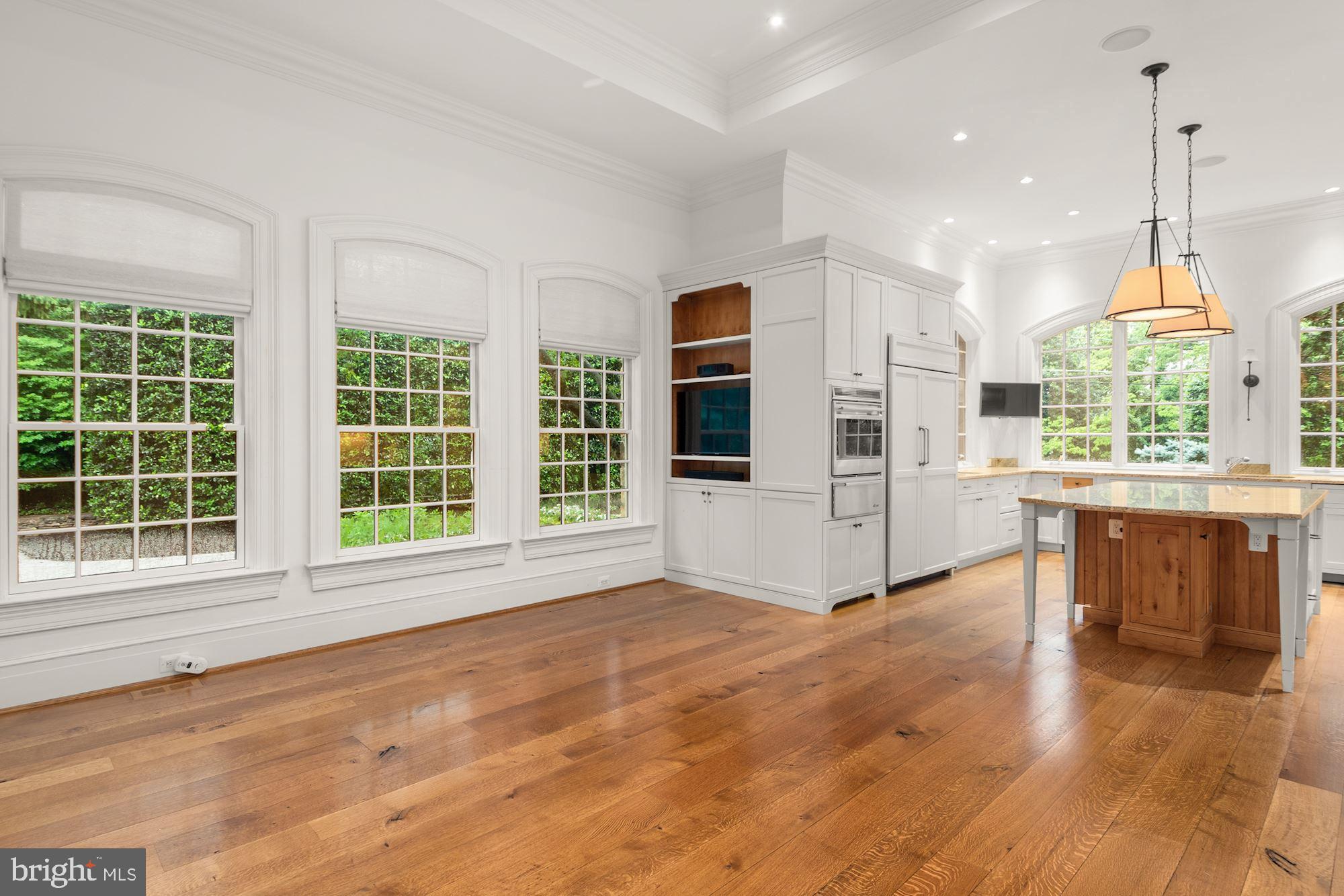 1107 Harvey Road McLean, VA 22101 - Photo 15 of 47 a view of an empty room with a window and wooden floor