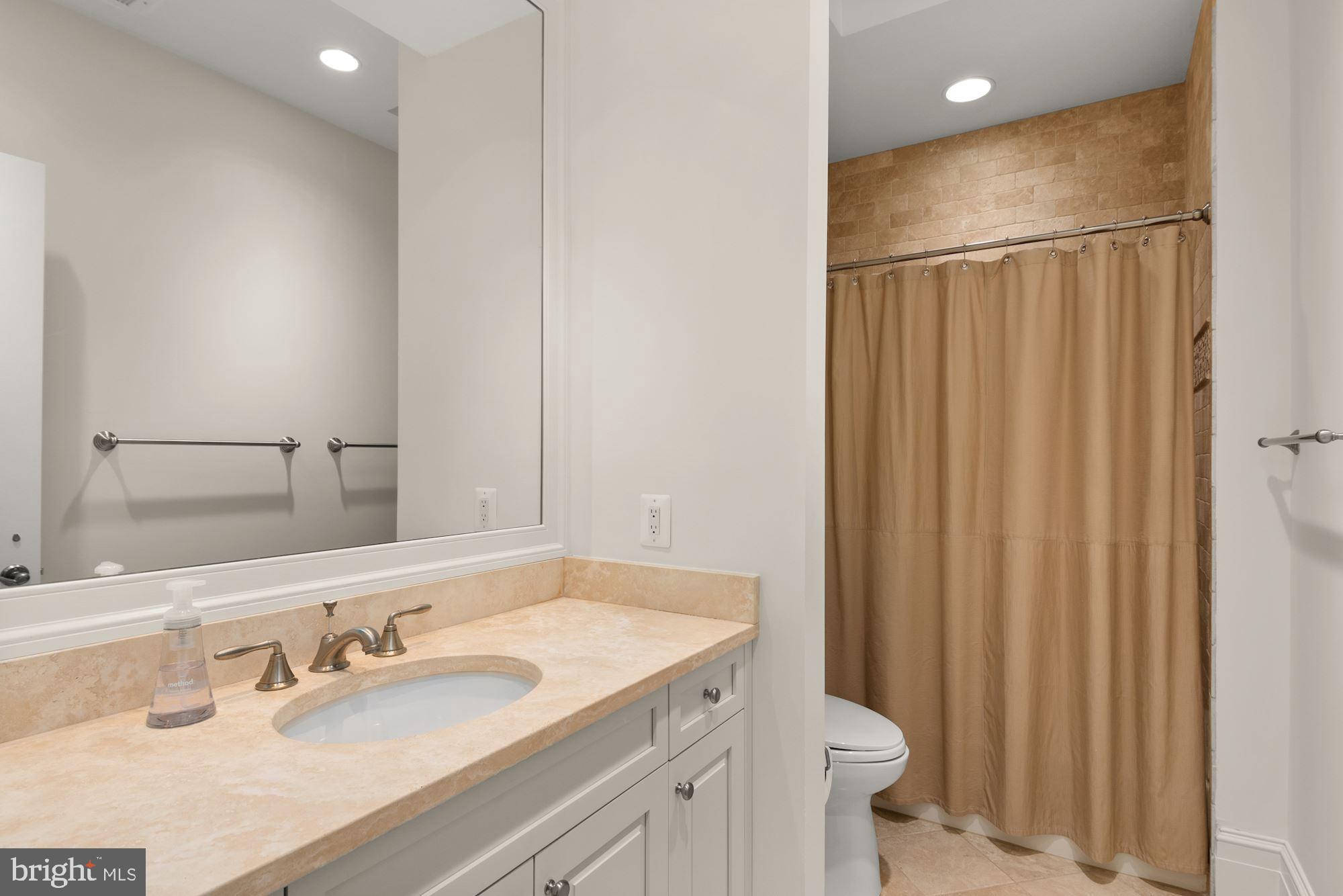 1107 Harvey Road McLean, VA 22101 - Photo 29 of 47 a bathroom with a sink and a mirror