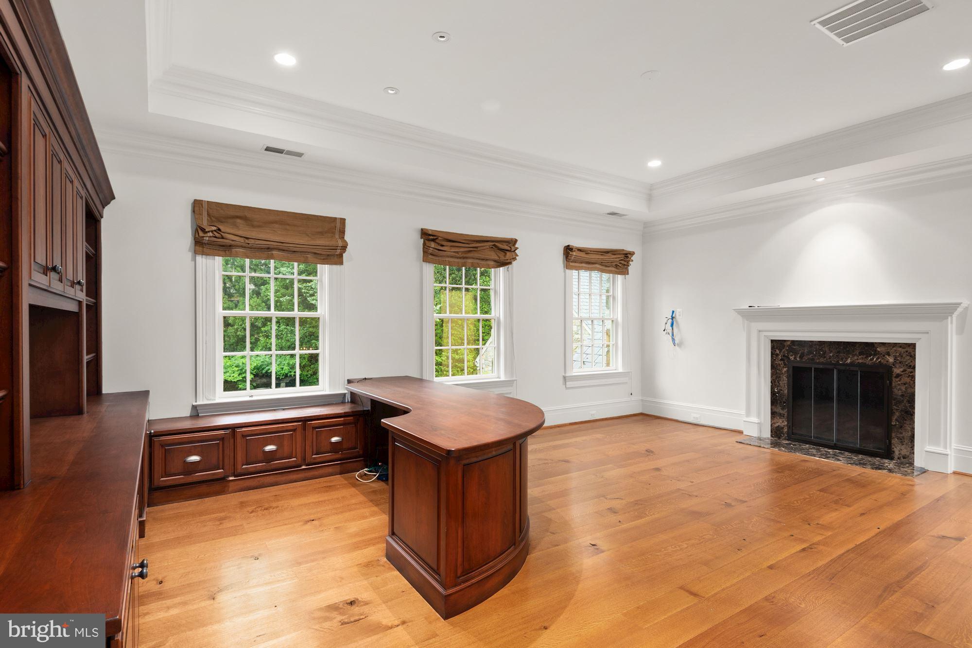 1107 Harvey Road McLean, VA 22101 - Photo 33 of 47 a spacious bedroom with a bed and a fireplace