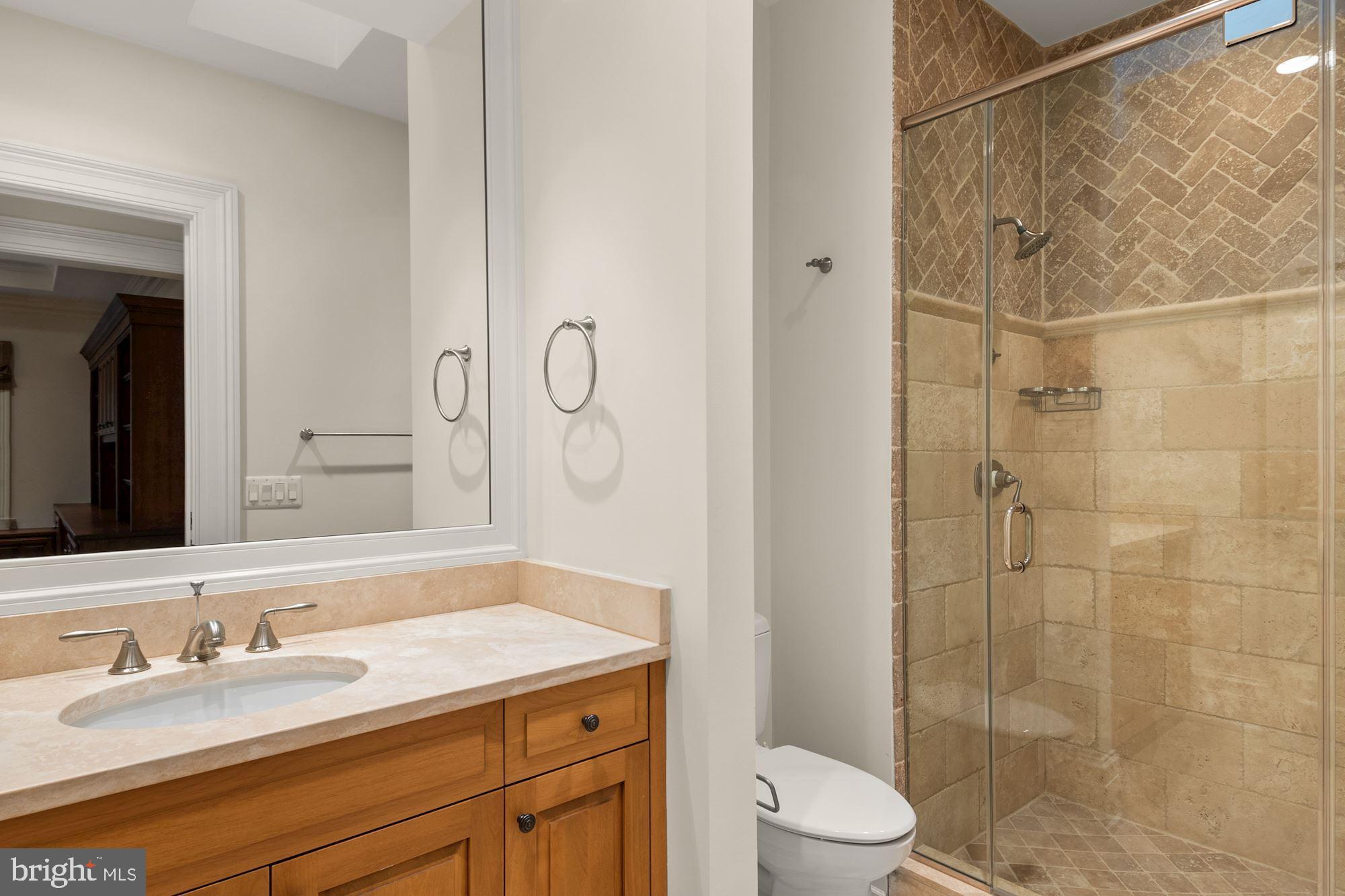 1107 Harvey Road McLean, VA 22101 - Photo 34 of 47 a bathroom with a granite countertop sink toilet and shower