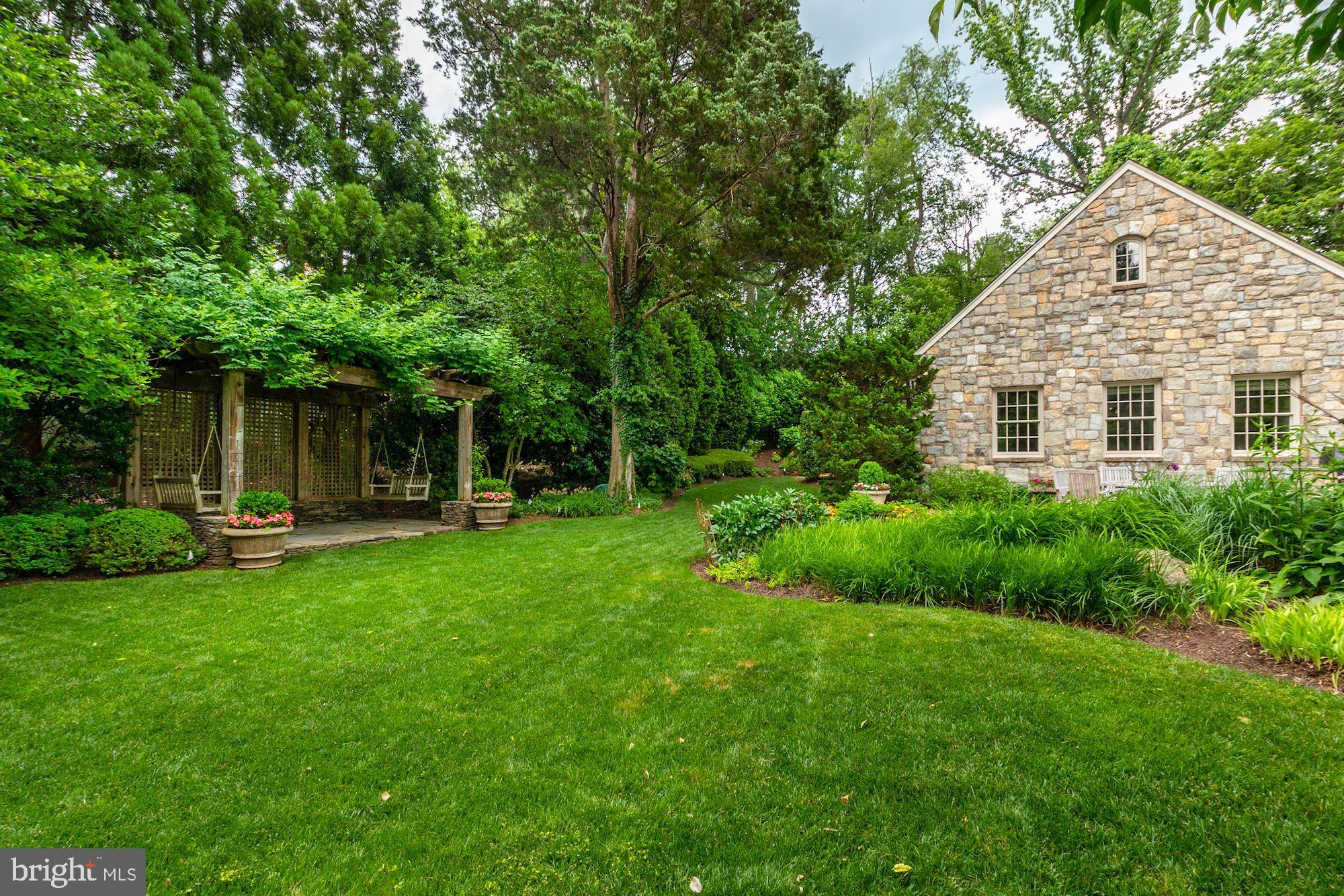 1107 Harvey Road McLean, VA 22101 - Photo 44 of 47 a view of a house with backyard sitting area and garden