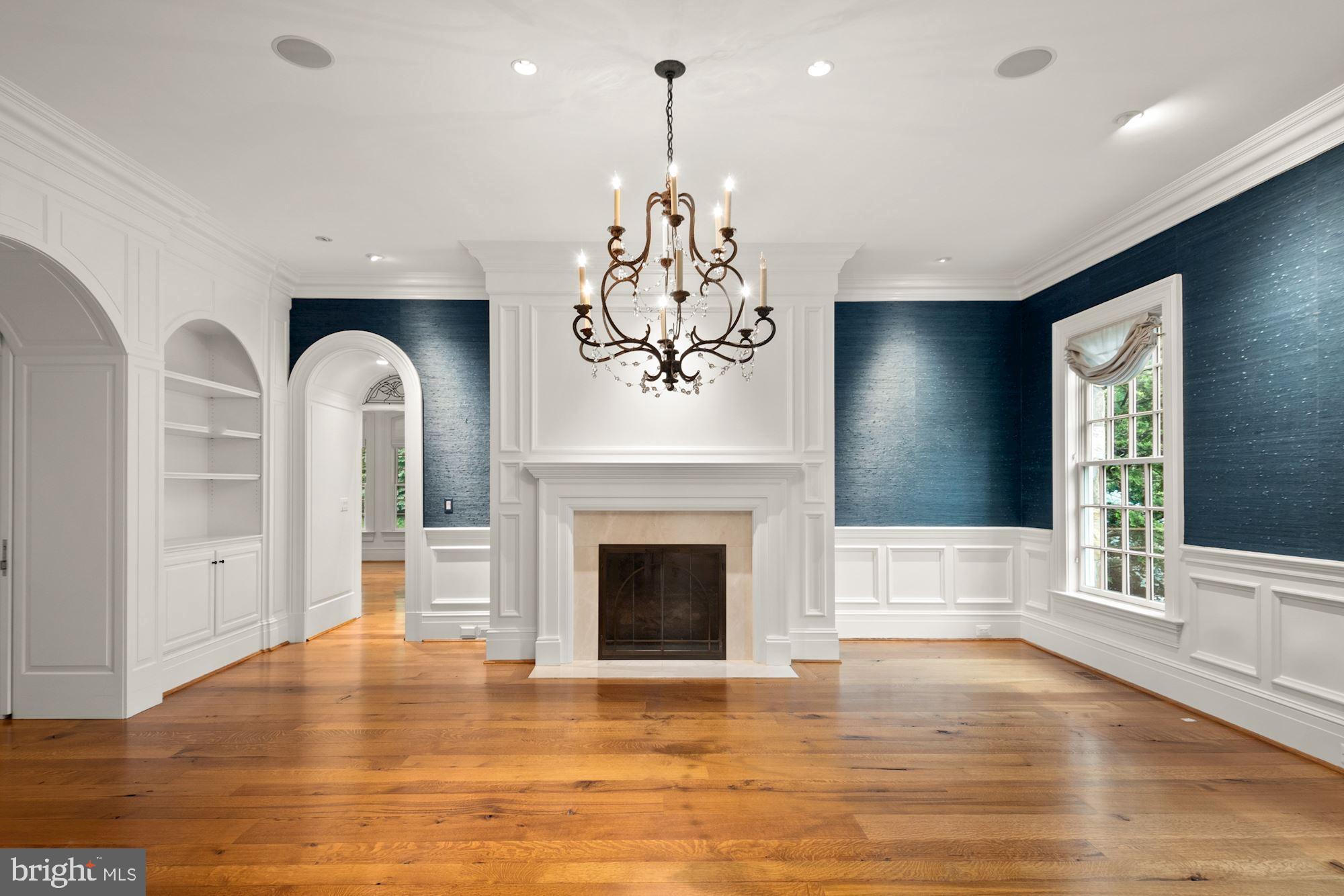 1107 Harvey Road McLean, VA 22101 - Photo 6 of 47 a view of a livingroom with a fireplace wooden floor and windows
