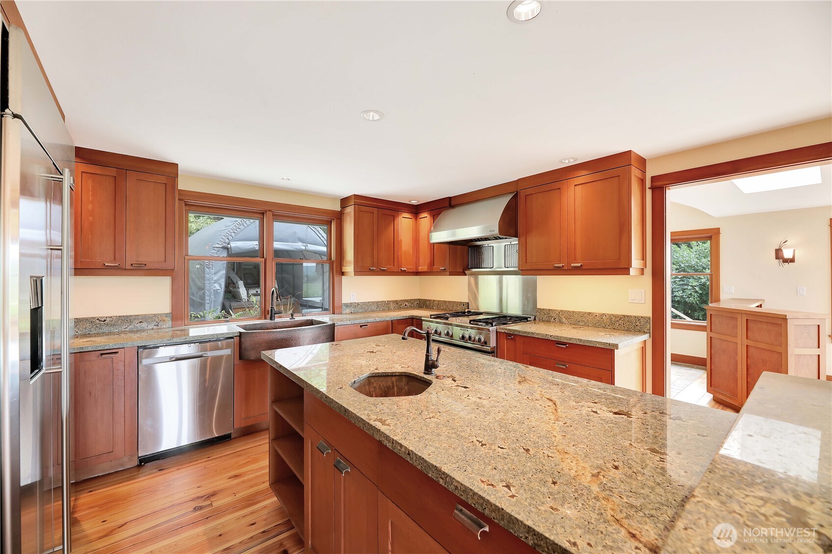 20226 Duvall Monroe Road Northeast Duvall, WA 98019 - Photo 8 of 38 a kitchen with stainless steel appliances granite countertop a sink a stove and a wooden floors