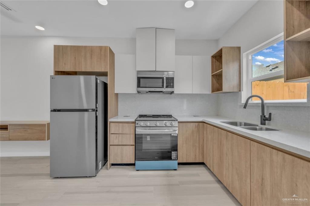 11509 North 25th Street, Unit C McAllen, TX 78504 - Photo 5 of 19 a kitchen with a refrigerator sink and stove