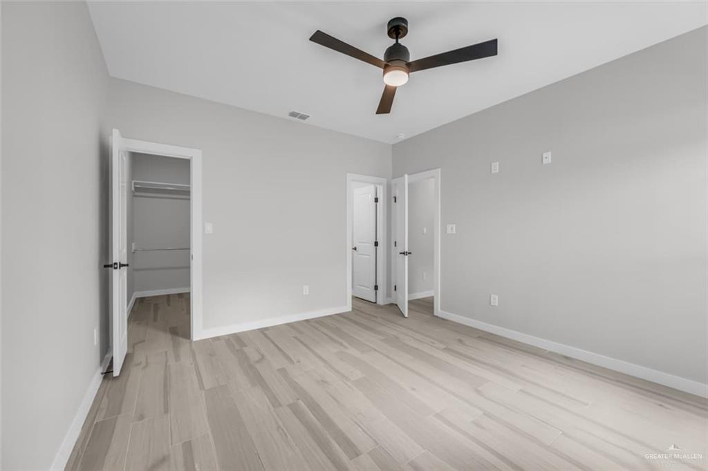 11509 North 25th Street, Unit C McAllen, TX 78504 - Photo 8 of 19 wooden floor in an empty room with a window