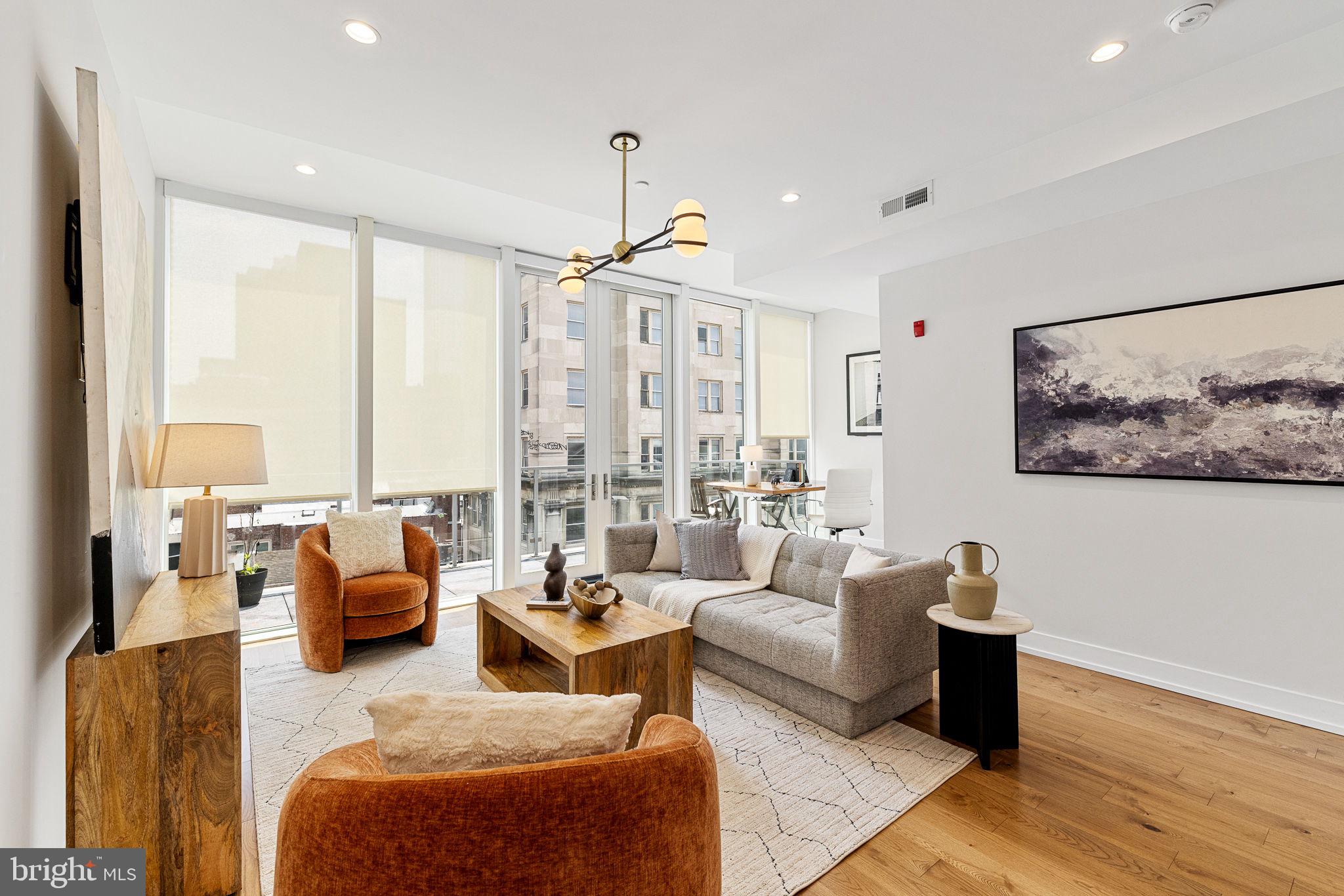 a living room with furniture potted plant and a large window