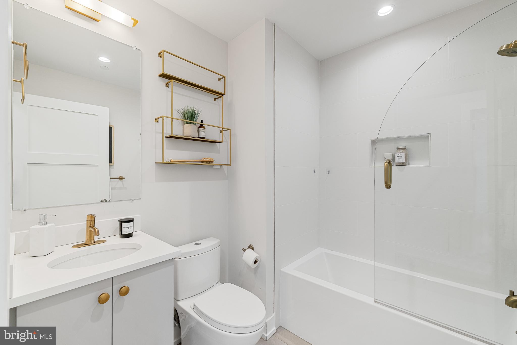 262 South 16th Street, Unit 7 Philadelphia, PA 19102 - Photo 15 of 36 a bathroom with a granite countertop sink a toilet and shower