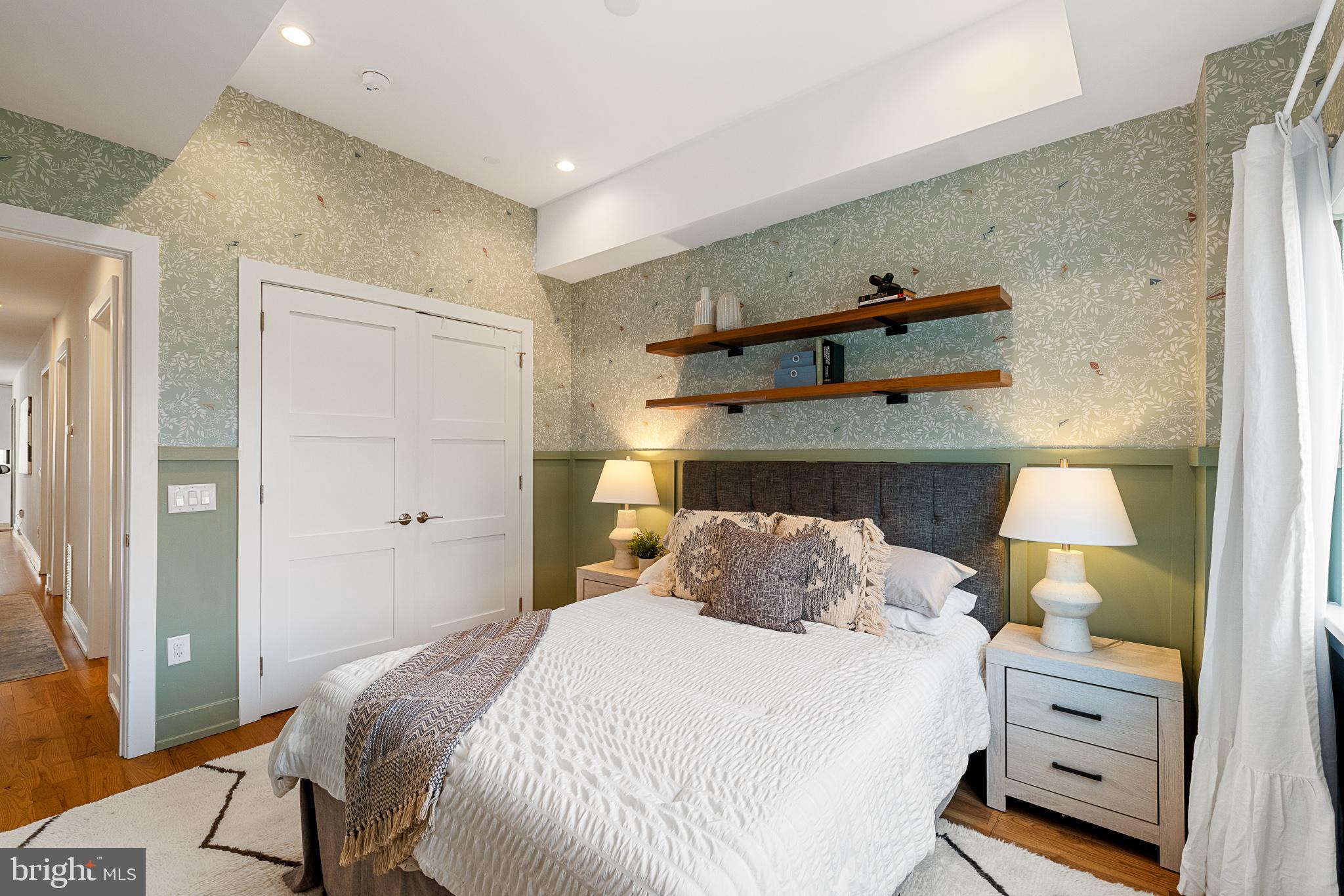 262 South 16th Street, Unit 7 Philadelphia, PA 19102 - Photo 17 of 36 a bedroom with a bed and wooden floor
