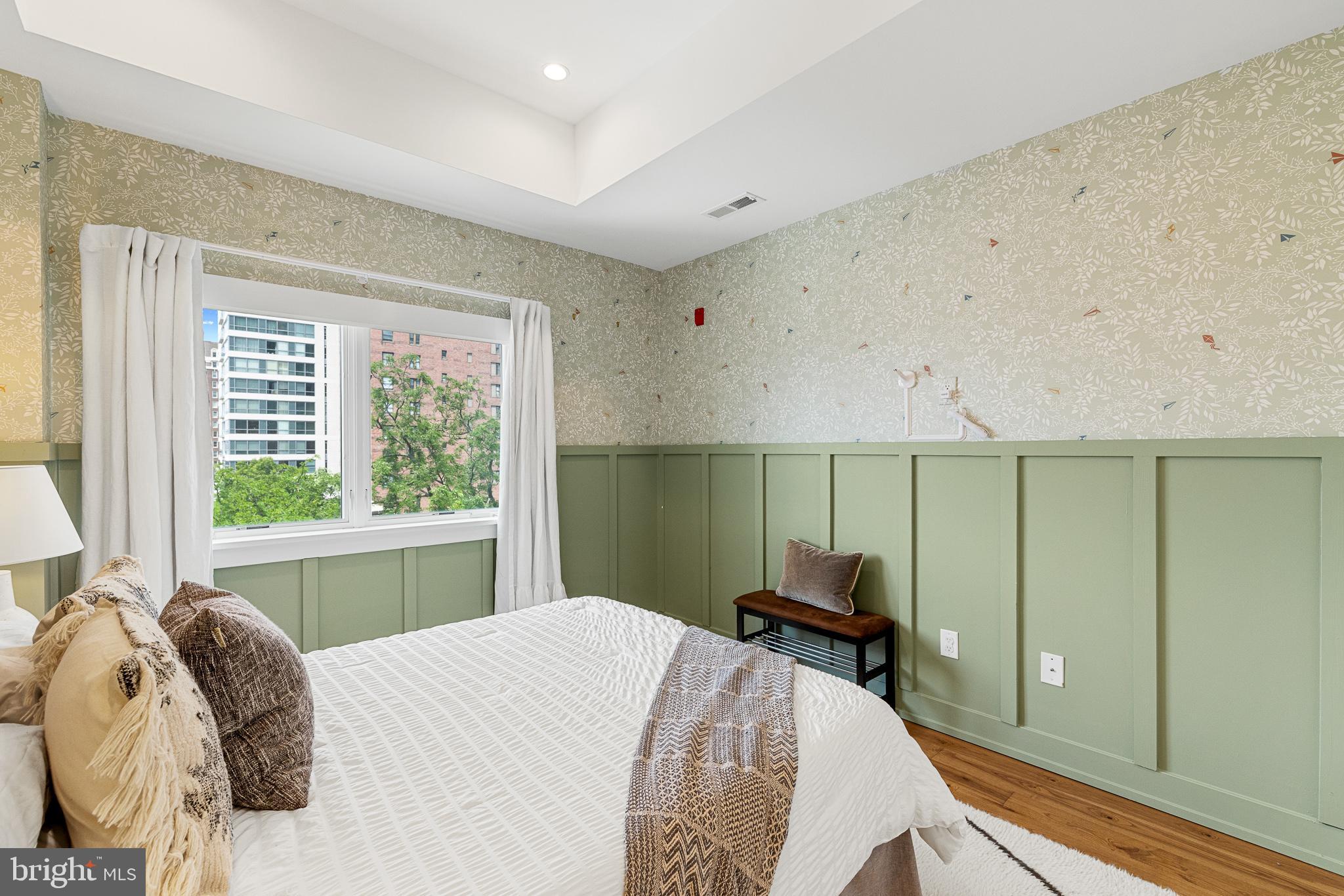 262 South 16th Street, Unit 7 Philadelphia, PA 19102 - Photo 18 of 36 a bed sitting in a bedroom next to a window