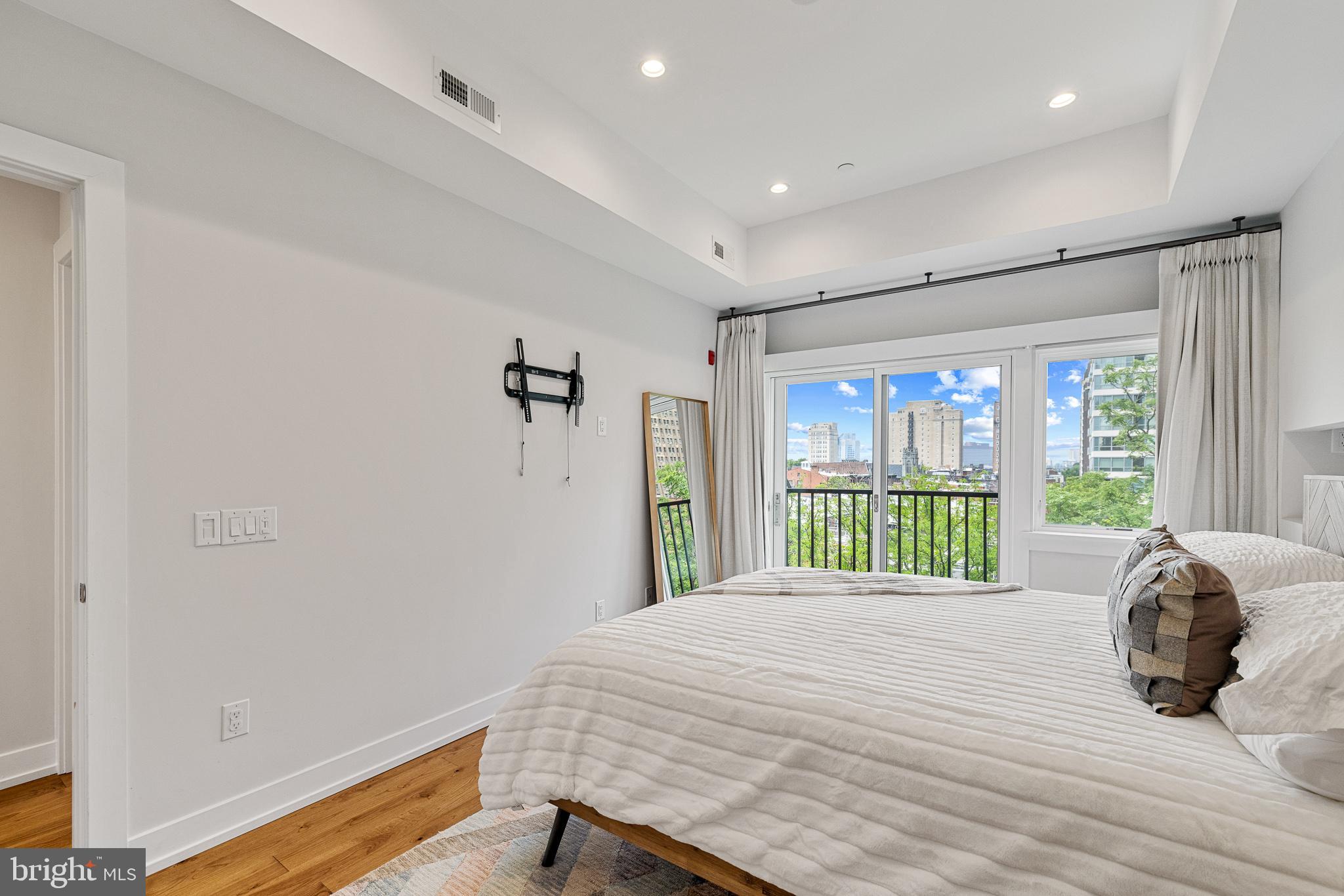 262 South 16th Street, Unit 7 Philadelphia, PA 19102 - Photo 20 of 36 a bedroom with a bed and a window