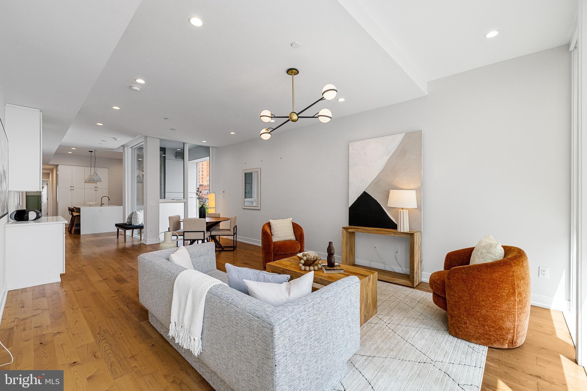 262 South 16th Street, Unit 7 Philadelphia, PA 19102 - Photo 2 of 36 a living room with furniture and a chandelier