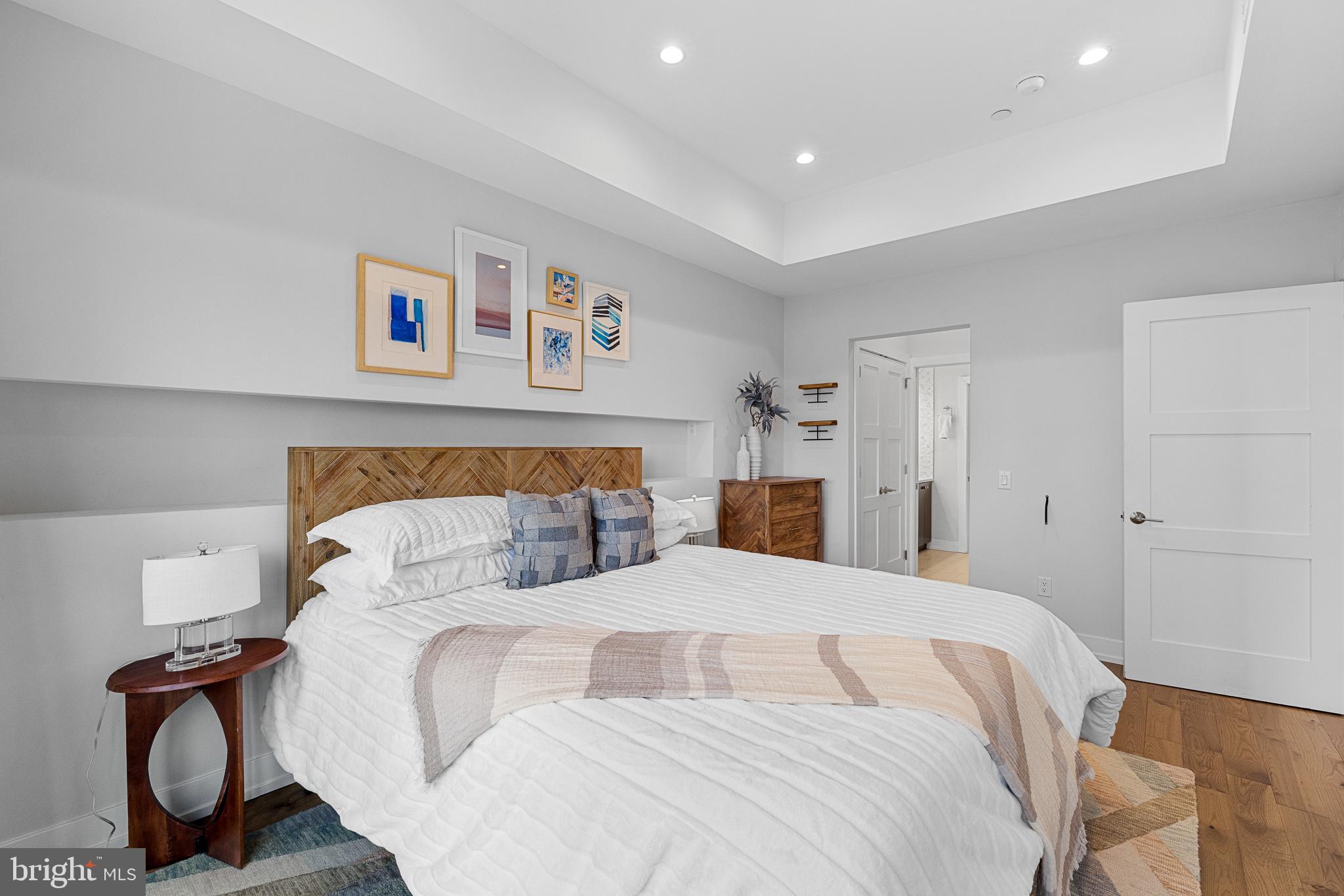 262 South 16th Street, Unit 7 Philadelphia, PA 19102 - Photo 21 of 36 a bedroom with a bed and a painting on the wall