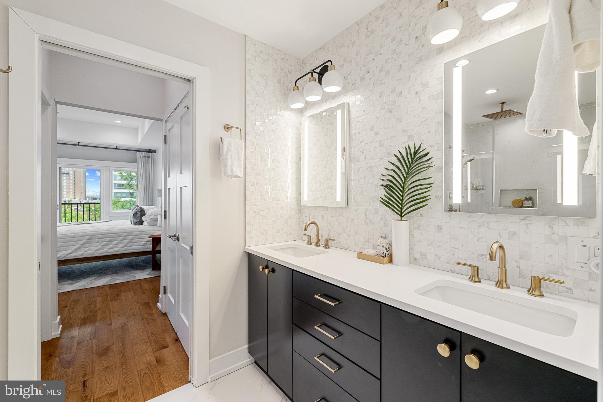 262 South 16th Street, Unit 7 Philadelphia, PA 19102 - Photo 24 of 36 a en suite bathroom with a double vanity sink and mirror