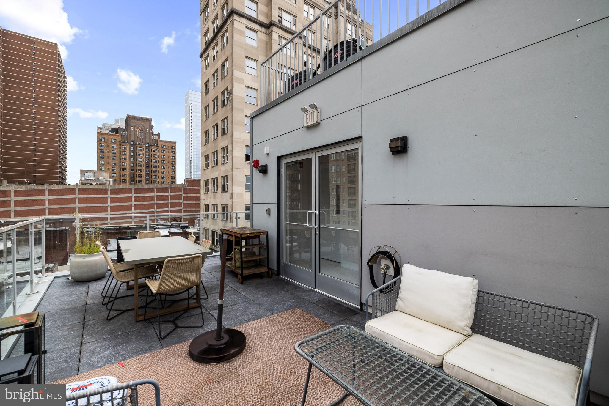 262 South 16th Street, Unit 7 Philadelphia, PA 19102 - Photo 30 of 36 a view of a patio with couches chairs and wooden floor