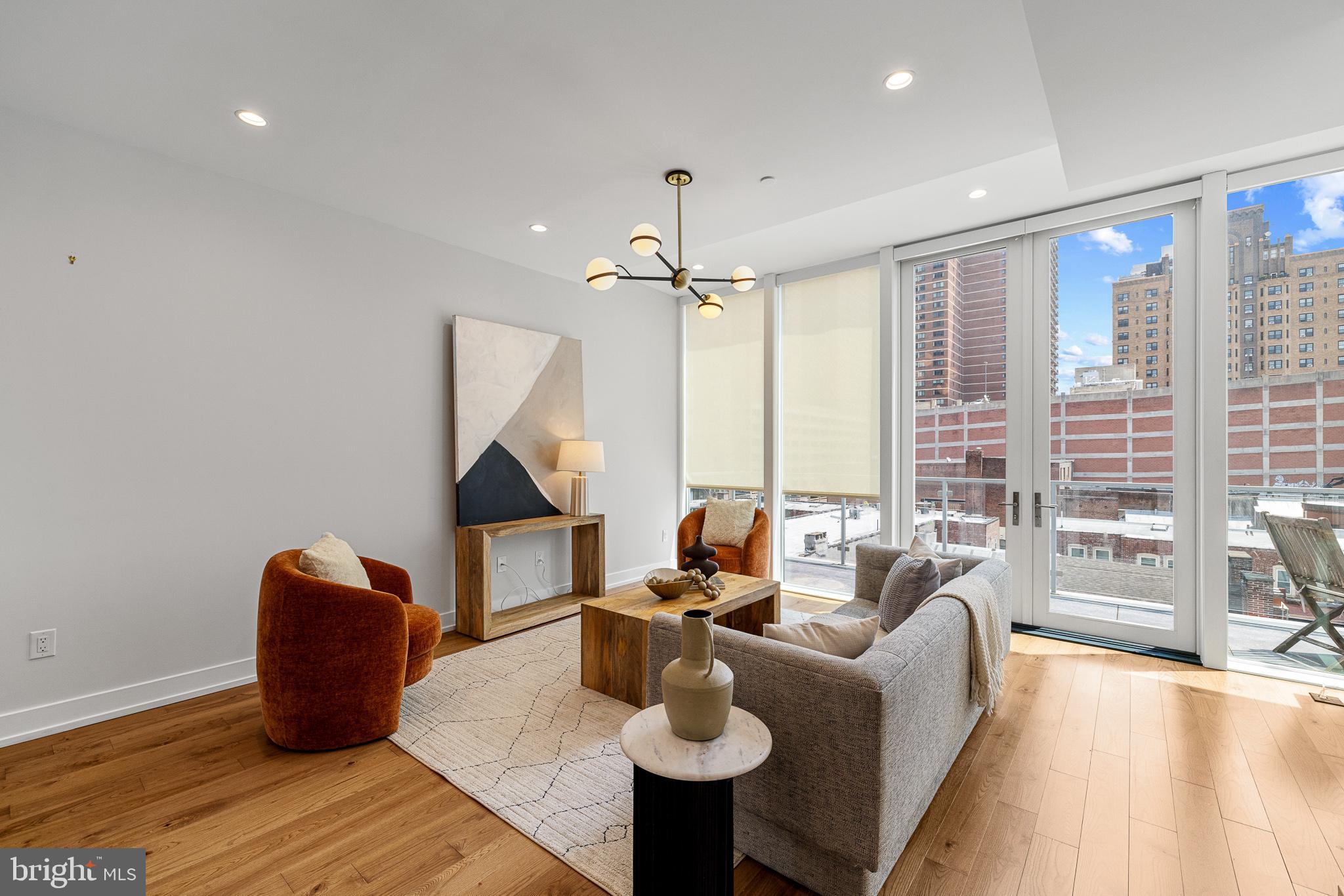 262 South 16th Street, Unit 7 Philadelphia, PA 19102 - Photo 3 of 36 a living room with furniture a rug and a chandelier