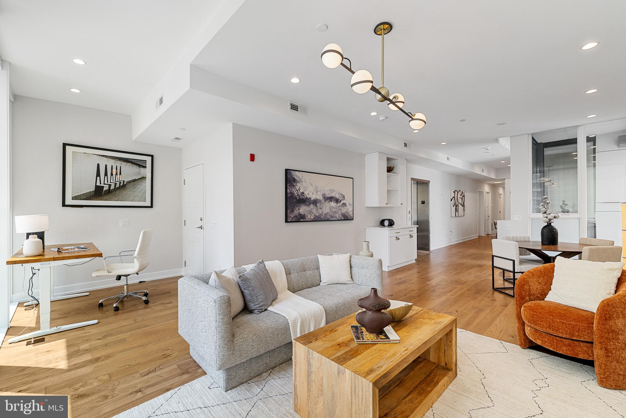 262 South 16th Street, Unit 7 Philadelphia, PA 19102 - Photo 4 of 36 a living room with furniture kitchen view and a chandelier