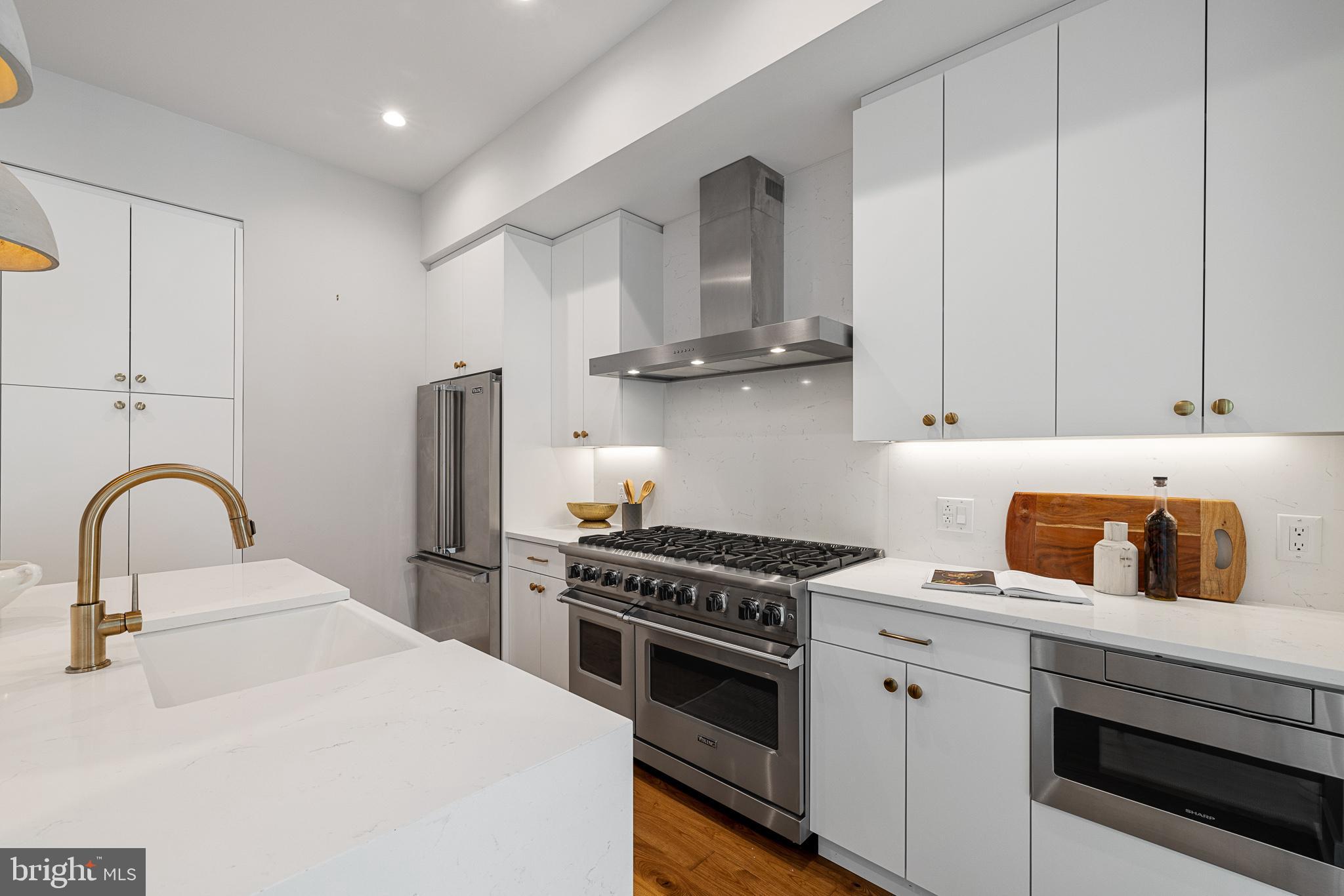 262 South 16th Street, Unit 7 Philadelphia, PA 19102 - Photo 7 of 36 a kitchen with cabinets a sink and stainless steel appliances