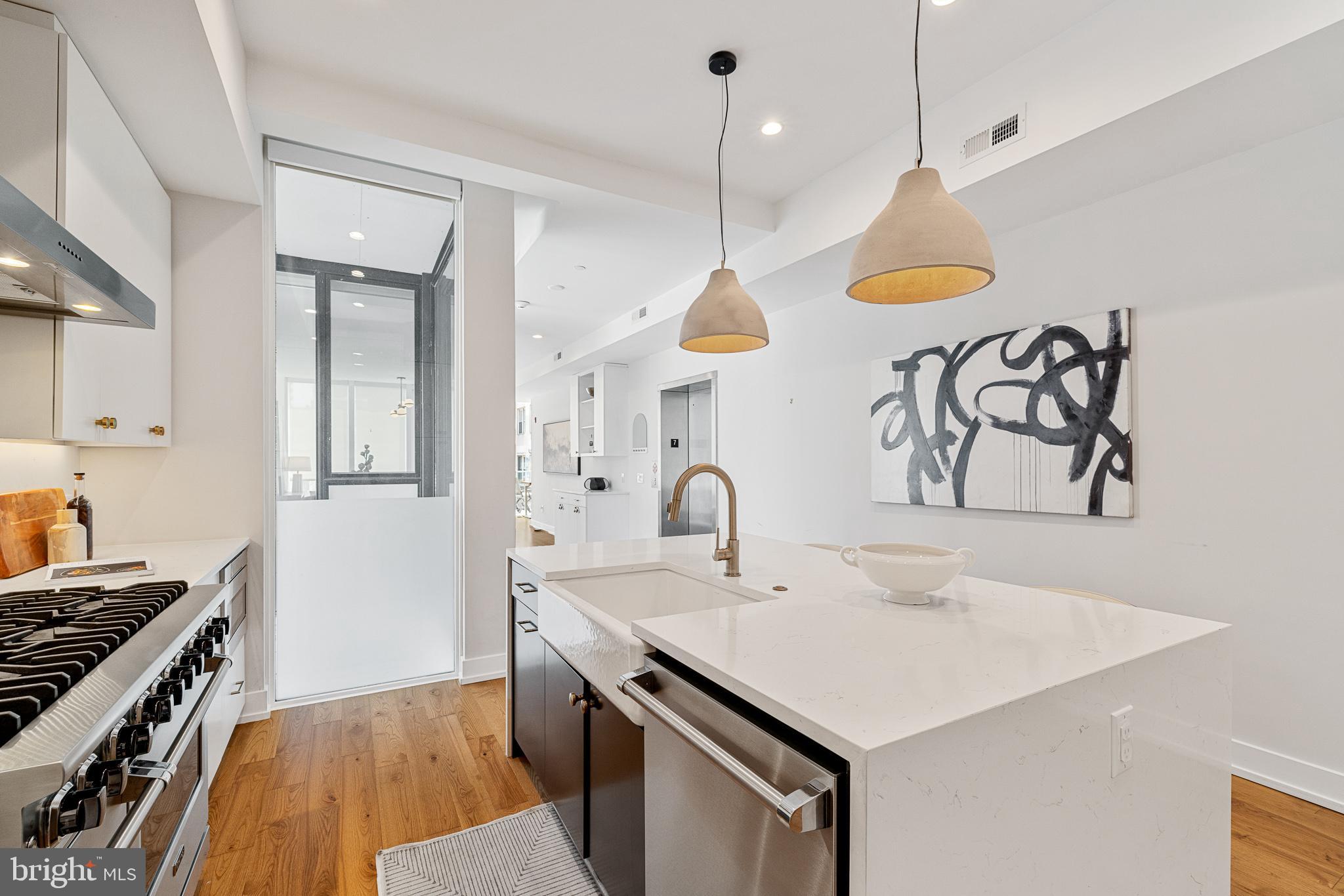 262 South 16th Street, Unit 7 Philadelphia, PA 19102 - Photo 8 of 36 a kitchen with a sink a stove and a refrigerator