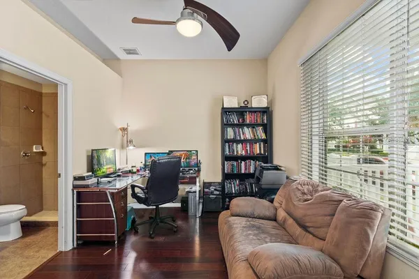 a living room with furniture and a wooden floor