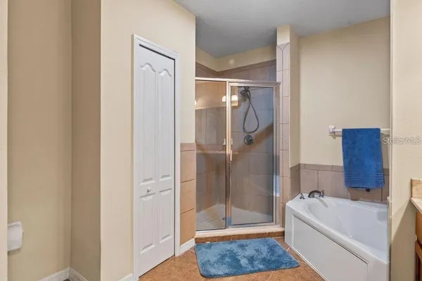 a bathroom with a tub shower and a sink